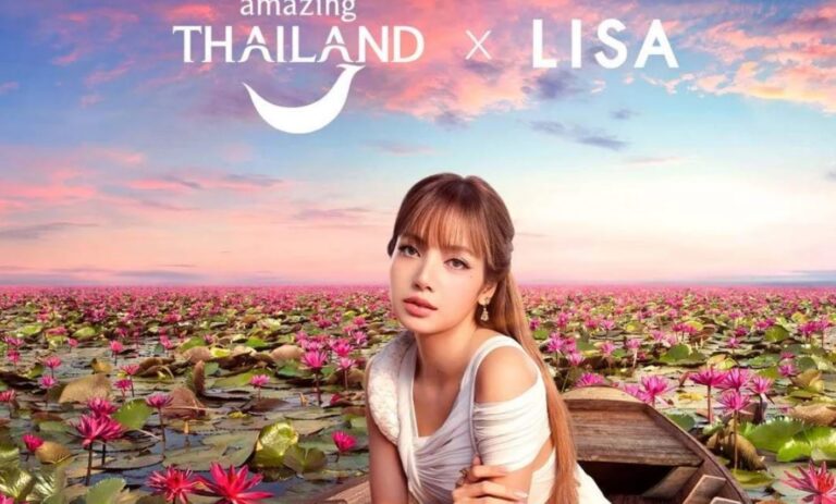 BLACKPINK Lisa sitting in a wooden boat surrounded by blooming pink water lilies under a vibrant sky, promotional image for Amazing Thailand campaign.
