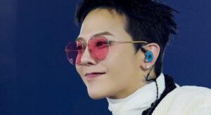 Stylish performer G-Dragon with pink shades on stage