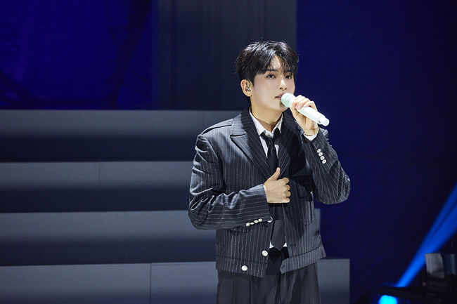 Ryeowook performs on a stage.