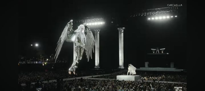 Coachella stage with Anyma’s holographic winged figure above the audience during live set.