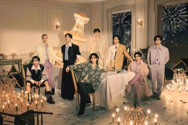 Stray Kids members pose for a camera.