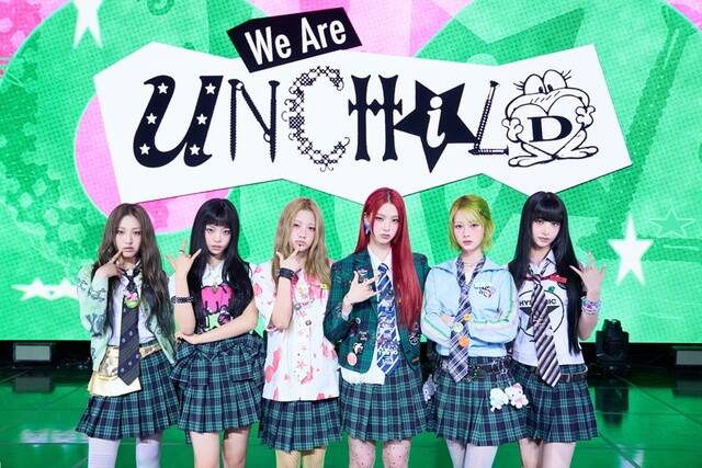 UNCHILD members stand in school‑uniform‑inspired outfits on stage with a bright green “We Are UNCHILD” banner.