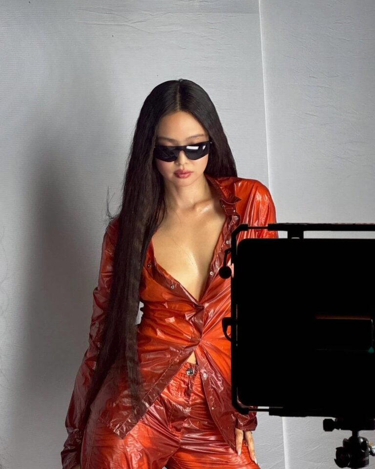 Fashion photo of BLACKPINK’s Jennie in translucent clothing with structured shoulders, highlighting delicate textures.