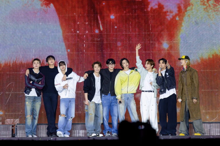 SEVENTEEN members react to fans during a concert.