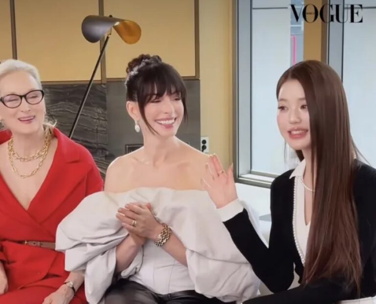 Jang Wonyoung sits with Meryl Streep and Anne Hathaway during a Vogue Korea interview, all three laughing together on a sofa in a bright studio.