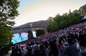 Fans and visitors to Seoul Children's Grand Park watch ILLIT's performance.