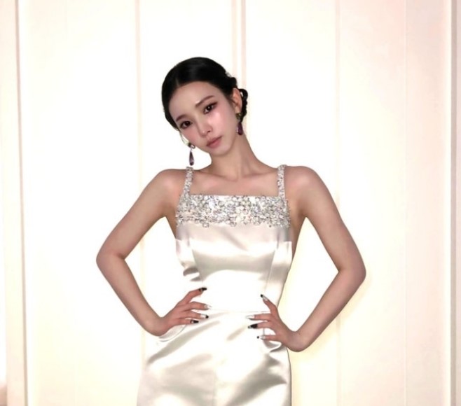 Karina stuns at the Met Gala in a crystal‑embellished silk white backless gown.