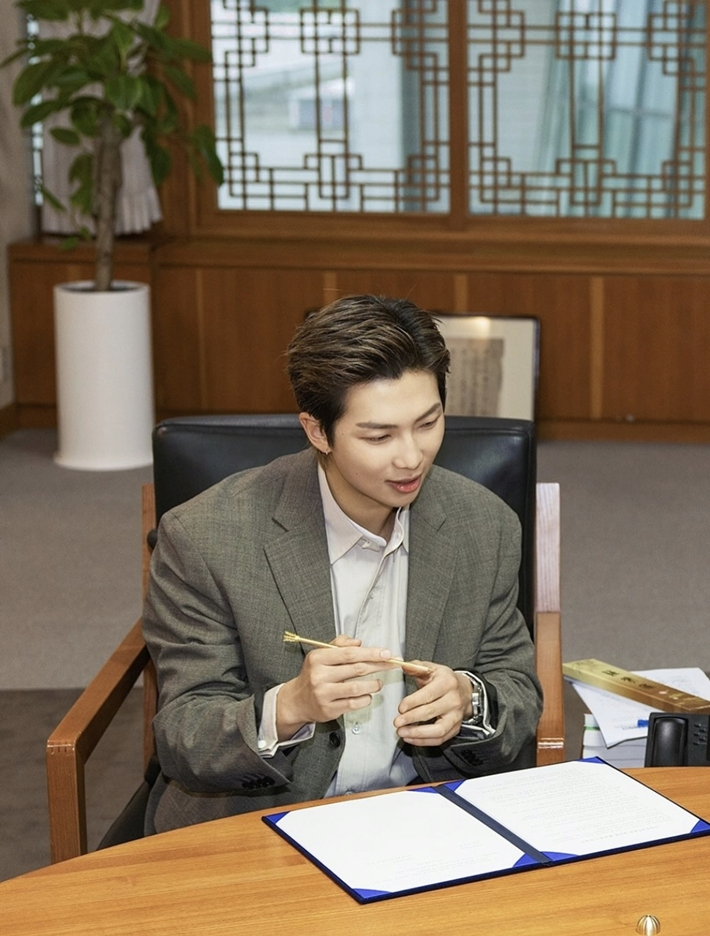 BTS's leader RM signs a document on the appointment of global ambassador for National Museum of Korea in Seoul.