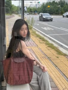 ITZY’s Chaeryeong sits at a bus stop ahead of her reported November 2026 solo debut.