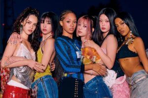 Six stylish individuals posing together at night in bold, textured outfits.