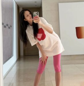 BLACKPINK Jisoo poses for a mirror selfie inside her art-filled home.
