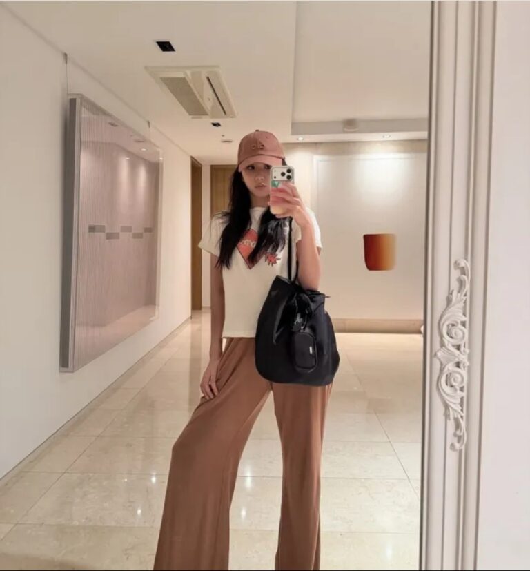 BLACKPINK Jisoo poses for a mirror selfie inside her art-filled home.