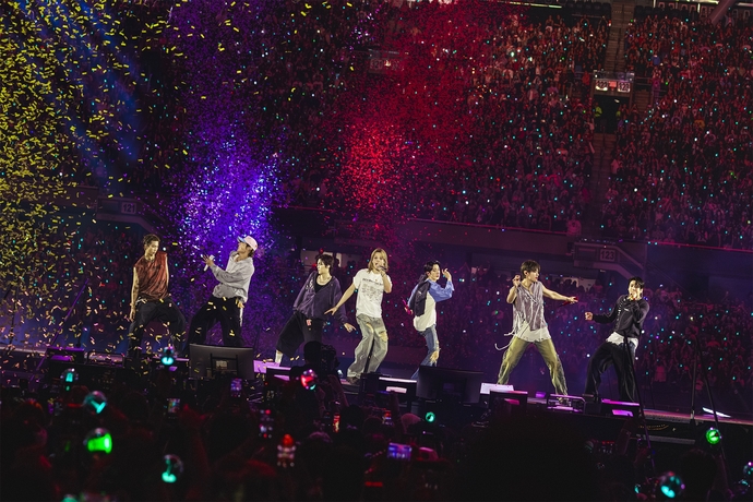 Jungkook and members performing during BTS ARIRANG World Tour in Los Angeles.