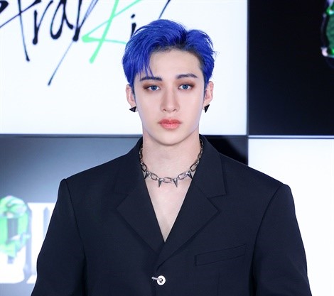 Stray Kid's member Bang Chan pose for a camera.