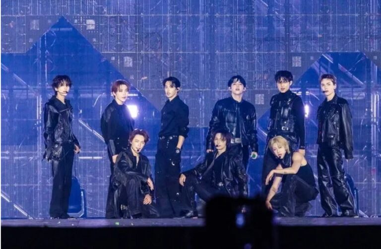 SEVENTEEN members perform together onstage during a concert